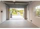 Bright and airy garage with an open view of the backyard at 83 Palm Blvd, Dunedin, FL 34698