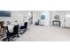 Basement sitting area with two blue chairs and a desk at 83 Palm Blvd, Dunedin, FL 34698
