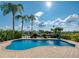 Inviting kidney-shaped pool with patio and water feature, offering water views at 6240 Bayside Dr, New Port Richey, FL 34652