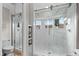 Large walk-in shower with marble tile and glass enclosure at 6240 Bayside Dr, New Port Richey, FL 34652