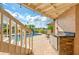 View of the pool and patio area from under the covered patio at 6240 Bayside Dr, New Port Richey, FL 34652