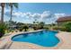 Relaxing kidney-shaped pool surrounded by a brick patio; peaceful canal view at 6240 Bayside Dr, New Port Richey, FL 34652