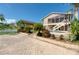 Home with paved patio, pool, lush landscaping, and screened-in porch at 6240 Bayside Dr, New Port Richey, FL 34652