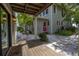 Relaxing back patio with wooden deck and walkway leading to the house at 516 Gulf Blvd, Indian Rocks Beach, FL 33785