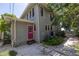Gray house exterior with red door, landscaping, and a stone pathway at 516 Gulf Blvd, Indian Rocks Beach, FL 33785