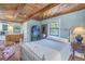 Cozy bedroom with a white metal bed frame and wood ceiling at 516 Gulf Blvd, Indian Rocks Beach, FL 33785