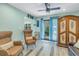 Light and airy living room with two comfy armchairs and access to the patio at 516 Gulf Blvd, Indian Rocks Beach, FL 33785