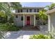 Two-story house with red door and stone pathway at 516 Gulf Blvd, Indian Rocks Beach, FL 33785