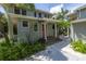 Two-story house with red door and stone pathway at 516 Gulf Blvd, Indian Rocks Beach, FL 33785