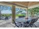 Covered outdoor dining area with ocean view, and wooden table with chairs at 516 Gulf Blvd, Indian Rocks Beach, FL 33785