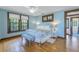 Charming bedroom with hardwood floors, a queen-size bed, and soft blue walls at 516 Gulf Blvd, Indian Rocks Beach, FL 33785