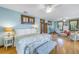 Comfortable bedroom with hardwood floors, a plush bed, and plenty of natural light at 516 Gulf Blvd, Indian Rocks Beach, FL 33785