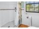 Small bathroom with shower and seashell-themed decor at 516 Gulf Blvd, Indian Rocks Beach, FL 33785