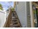 Wooden staircase leading to upper level of home at 516 Gulf Blvd, Indian Rocks Beach, FL 33785