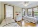 Charming bedroom with hardwood floors, twin beds, and plenty of natural light at 516 Gulf Blvd, Indian Rocks Beach, FL 33785