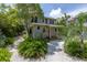 Two-story house with red door and garden at 516 Gulf Blvd, Indian Rocks Beach, FL 33785