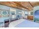 Cozy bedroom with wood beam ceiling and kitchenette access at 516 Gulf Blvd, Indian Rocks Beach, FL 33785