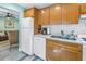 Well-equipped kitchen with light wood cabinets and stainless steel appliances at 516 Gulf Blvd, Indian Rocks Beach, FL 33785