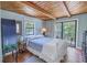 Charming bedroom with wood beam ceilings and private balcony at 516 Gulf Blvd, Indian Rocks Beach, FL 33785