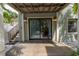 Back patio with wooden flooring and sliding glass doors leading inside at 516 Gulf Blvd, Indian Rocks Beach, FL 33785