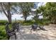 Ocean view patio with chairs, table, and lush tropical landscaping at 516 Gulf Blvd, Indian Rocks Beach, FL 33785