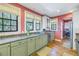 Kitchen boasts granite countertops, stainless steel appliances, and light green cabinets at 516 Gulf Blvd, Indian Rocks Beach, FL 33785