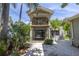 Two-story house with balcony and lush landscaping at 516 Gulf Blvd, Indian Rocks Beach, FL 33785