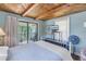 Bedroom with wood beam ceiling, access to balcony, and TV at 516 Gulf Blvd, Indian Rocks Beach, FL 33785