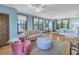 Spacious bedroom with hardwood floors, large windows, and seating area at 516 Gulf Blvd, Indian Rocks Beach, FL 33785