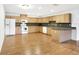 U-shaped kitchen with light wood cabinets and laminate flooring at 6700 90Th N Ave, Pinellas Park, FL 33782