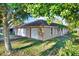 Tan house with a two-car garage and mature landscaping at 6700 90Th N Ave, Pinellas Park, FL 33782