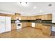 U-shaped kitchen with light wood cabinets and laminate flooring at 6700 90Th N Ave, Pinellas Park, FL 33782