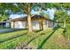 Tan house with a two-car garage and lush lawn at 6700 90Th N Ave, Pinellas Park, FL 33782