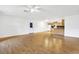 Open living area with laminate floors and kitchen access at 6700 90Th N Ave, Pinellas Park, FL 33782