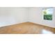 Bright bedroom featuring light laminate flooring and a window at 6700 90Th N Ave, Pinellas Park, FL 33782