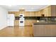 U-shaped kitchen with light wood cabinets and laminate flooring at 6700 90Th N Ave, Pinellas Park, FL 33782