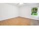 Spacious bedroom with laminate flooring and a window at 6700 90Th N Ave, Pinellas Park, FL 33782