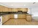 U-shaped kitchen with light wood cabinets and laminate flooring at 6700 90Th N Ave, Pinellas Park, FL 33782