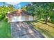 Two-car garage with driveway and surrounding lawn at 6700 90Th N Ave, Pinellas Park, FL 33782