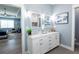 Double vanity bathroom with white cabinets and view of bedroom at 83 Palm Blvd, Dunedin, FL 34698