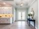 Bright entryway with white cabinets, hardwood floors, and a blue console table at 83 Palm Blvd, Dunedin, FL 34698