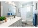 Bathroom with marble tile, white vanity, and bathtub at 83 Palm Blvd, Dunedin, FL 34698