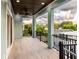 Covered balcony with wood-look tile and neighborhood view at 83 Palm Blvd, Dunedin, FL 34698