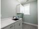 Laundry room with white cabinets and a utility sink at 83 Palm Blvd, Dunedin, FL 34698