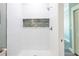 Clean shower with white wave tile and a stone accent at 83 Palm Blvd, Dunedin, FL 34698