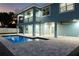 Two-story house with a pool and backyard at dusk at 83 Palm Blvd, Dunedin, FL 34698