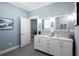 Double vanity bathroom with white cabinets and a large mirror at 83 Palm Blvd, Dunedin, FL 34698