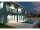 Two-story house with a pool and backyard at dusk at 83 Palm Blvd, Dunedin, FL 34698