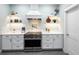 Modern kitchen with white cabinets, stainless steel appliances, and quartz countertops at 83 Palm Blvd, Dunedin, FL 34698