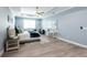 Main bedroom with king bed, light blue walls, and ceiling fan at 83 Palm Blvd, Dunedin, FL 34698